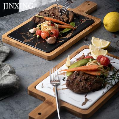 China Best Viable Selling Tray With Handle Nordic Steak Wooden Round Ceramic Pizza Dish Home Black Western Dinner Dish for sale