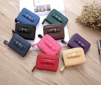 China Waterproof Mini PU Leather Wallet Ladies Short And Cute Coin Purse Student Head Case With Bow for sale