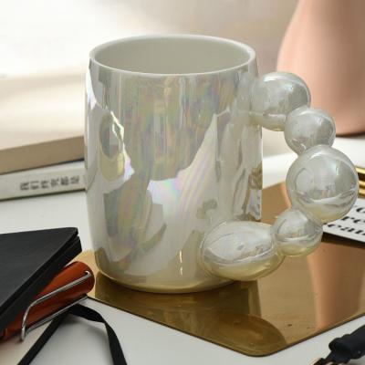 China Viable Custom Logo Ins Sugar Gourd Mug Nordic Pearlized Coffee Mug Art Ceramic With Rotating Ball Handle for sale