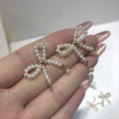 China Factory Direct Selling Sweet Girly Style 14K Gold Note Pearl Bowknot Cute Freshwater Earrings Wholesale First-hand Price for sale