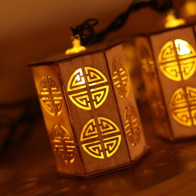 China Cute Chinese Style Creative Christmas Lights String Wood Hollow Out Pendant Led Lights For Decoration String for sale