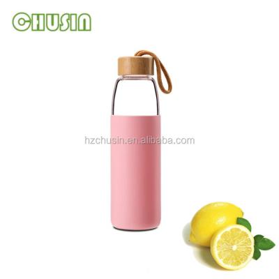 China 550ML Sustainable Glass Water Bottle With Silicone And Bamboo Sleeve Lid for sale