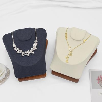 China Wood and microfiber adjust shape pattern neck necklace holder made of high end display of solid wood necklace and microfiber bead for sale