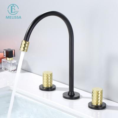 China Melissa Brass Bathroom Fashion Faucets Sense Black And Gold Split Handle Three Holes Bathroom Cabinet Hot And Cold Cabinet Type Double Basin Faucet for sale