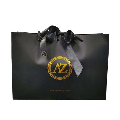 China Custom Recyclable Black Glossy Style Fashion Lamination Packaging Gift Shopping Paper Bag With Ribbon for sale