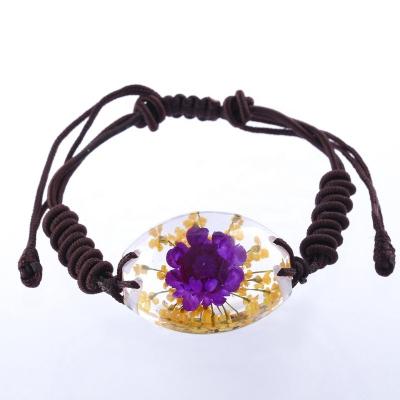 China Beautiful Real Flower Embedded Flower Bracelet For Girls Sweet Gift Real Flower Resin Bracelet With Fitted Knitted Rope for sale