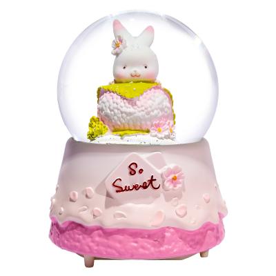 China Lovely Rabbit Garden Cartoon Makers Gift Daily Snow Globes Artificial Custom Water Ball Resin Opens LED Music Box for sale