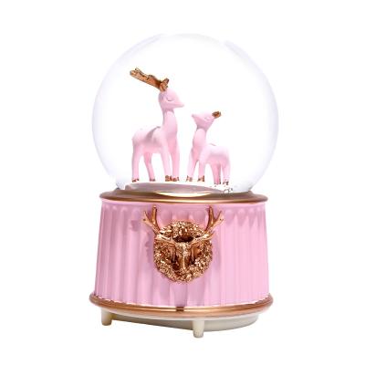 China Artificial Custom Wholesale Resin Opens Creative Pink Fawn Crystal Ball Music Box Musical Snow Globe Gift for sale