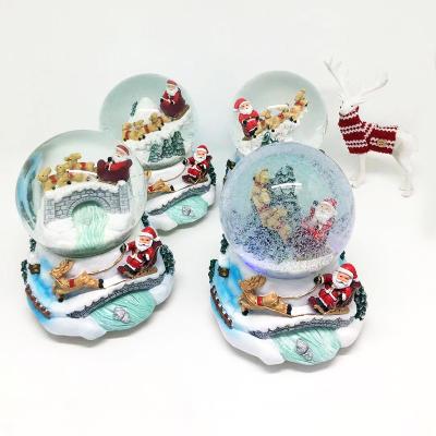 China Custom Hot Sale Artificial Christmas Decoration Resin Water Ball Christmas Gift Glass Snow Globe Music Boxes for sale