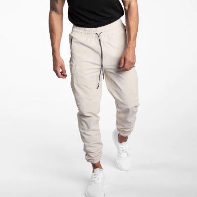 China Breathable Custom Cargo Pockets Waterproof Shell Relaxed Track Pant Fit Mesh Striping Sweatpants Gyms Jogger Track Pants Black for sale