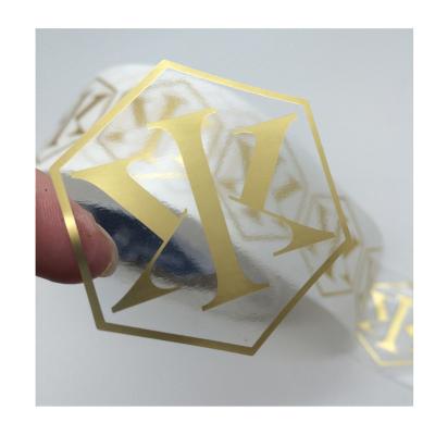 China Custom transparent PET shiny gold color logo sticker waterproof, logo printed gold foil stamping clear label for sale