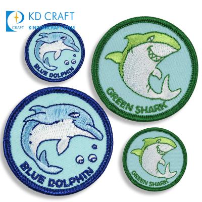 China fashion new personalized 3D custom cute logo ocean dolphin woven iron on clothing fabric embroidered animal patch for hat for sale