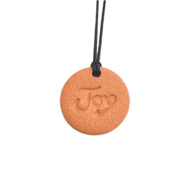 China Elegant Terracotta Clay Diffuser Pendant Ornament Ceramic Essential Oil Car Diffuser With Rope for sale