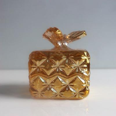 China Steamable Gold Plated Luxury Square Glass Candy Candle Storage Jars With Butterfly Shaped Lid for sale