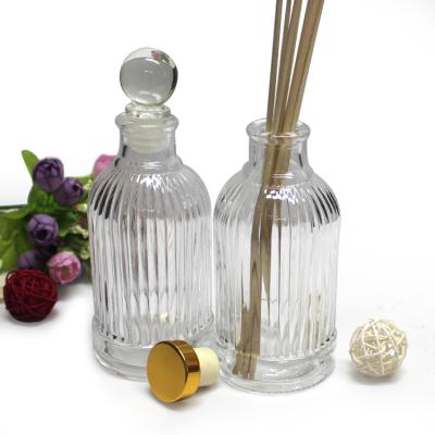 China Personal Care Tall Vertical Stripe Embossed Tall Tubular Glass Diffuser Empty Bottle With Cork for sale