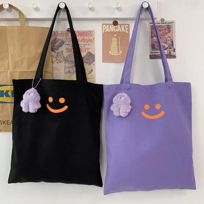 China 2021 New Lady Simple Canvas Tote Bags Women Shoulder Smile Students Bags With Bear Pendant For Girls for sale