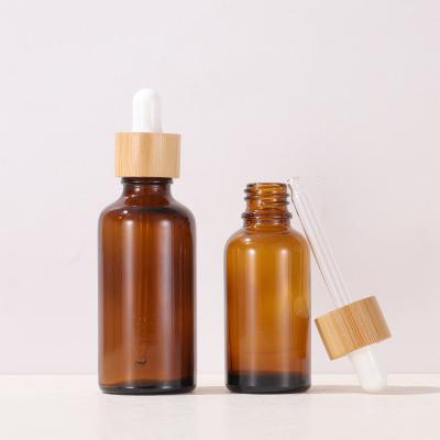 China 5ml 10ml 15ml 20ml 30ml 50ml 100ml Cosmetic Amber Glass Essential Oil Dropper Bottle With Bamboo Lid for sale