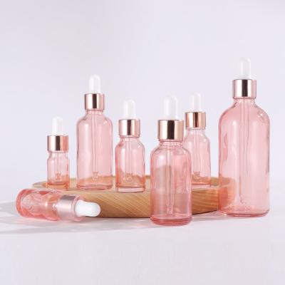 China 5ml 10ml 15ml 20ml 30ml 50ml 100ml cosmetic pink serum essential oil dropper glass bottle with pink gold cap paper tube for sale