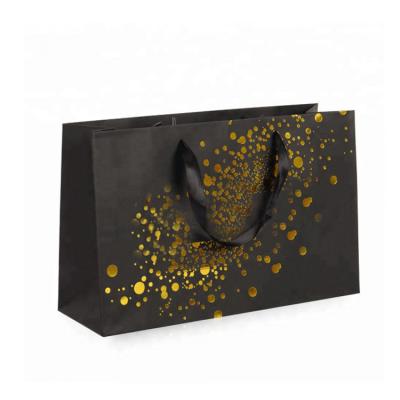 China New Logo Hot Foiled Stamping Black Matt Kraft Paper Bag With Gold Recyclable Cotton Rope Handles for sale