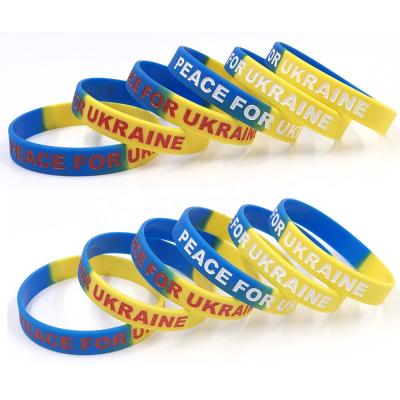 China Promotional Flag Debossed Rubber Silicone Bracelet Peace Ukraine Ink Filled Logo RTS For Ukraine Wristband for sale