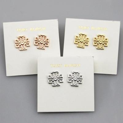 China Fashionable foreign trade European jewelry T logo texture copper hollow earrings plated with gold 2022 fashion stud earrings for girls for sale