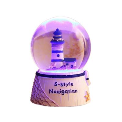 China Customized Lighthouse World Glass Sea Snowball Gift Resin Decorative Tabletop Ornament Led Auto Music Box Souvenir Snow Globes for sale