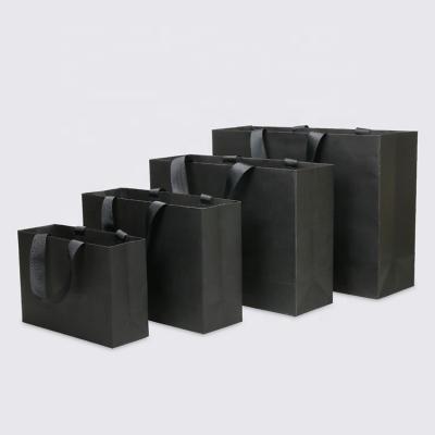 China 2023 Security Yiwu Factory Luxury Matte Black Gift Shopping Paper Bag Custom Design Logo for sale