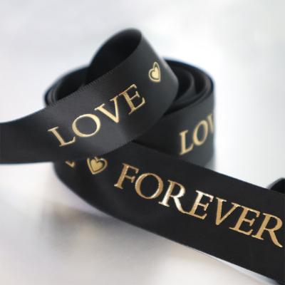 China Durable Black Gold Silver Foil Satin Ribbon Logo Stamping Love Forever Ribbon Gift Wrapping for sale