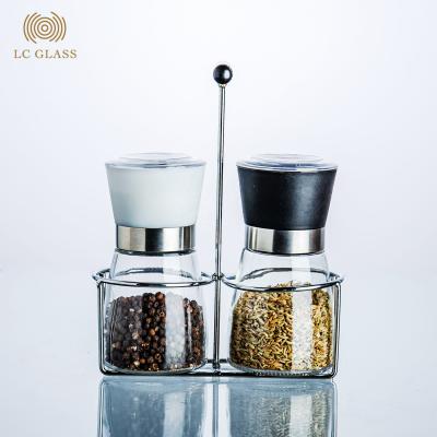 China Seasoning Glass Spice Tools 170ml Spice Salt And Pepper Griner Glass Bottle With Plastic Lid And Iron Holder for sale