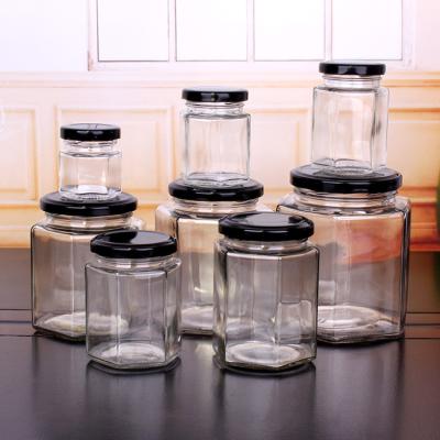 China A Most Popular Hot Selling Honey Hexagonal Glass Food Jar Freshness Preservation Hexagon Glass Jar With Metal Lid for sale