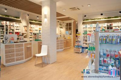 China Pharmacy interior space design Light color wood cabinet with storage drawers and Display stand by hook for sale