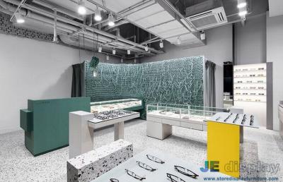 China Vigorous Eyeglass store interior design made by Green color painting display cabinets and Marble counters for sale