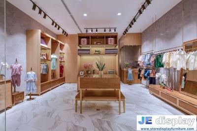 China Tienda del paño de los niños de los muebles de la exhibición del diseño interior por los gabinetes y los contadores de madera de pantalla a color con el sofá chai del ocio en venta