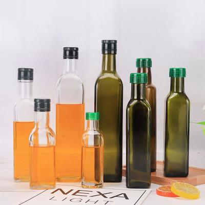 China Clear Empty Stored Olive Glass Transparent Round Oil Dispenser Bottle for sale