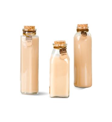 China Custom Personal Care Wholesale Juice Milk Container Clear 250/500ml Food Grade Material Beverage Glass Bottle With Cork for sale