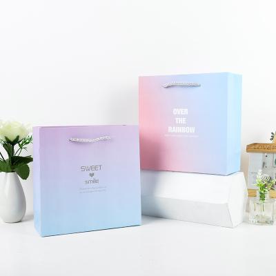 China Customize Gradient Handheld Christmas Day Gift Box Clothing Paper Bag Gift Packaging Bag for sale