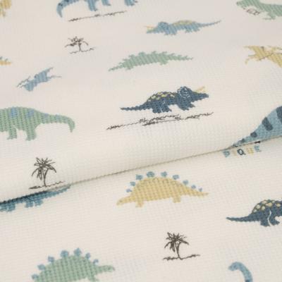 China Water Soluble Cute Cartoon Dinosaur Printed Micro Waffle Cotton Fabric For Baby Kids Printed Fabric Knit Fabric 100% Cotton for sale