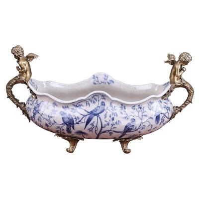 China Art Decor Fruit Bowl Oval Wavy Mouth European Style Retro Decorated Ceramic Fruit Bowl with Two Brass Angels for Living Room Home Decor for sale