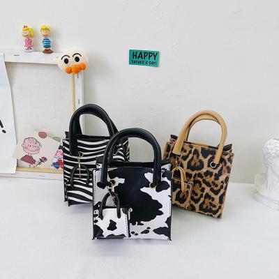 China 2022 Fashionable Cow Print Purse Messenger Bag Pu Leather Cross - Body Bags Children Drop Purse Baby Child Mini Handbag Trendy For Little Girls for sale