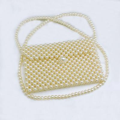 China Handmade Popular Long Strap Cross Body Wrap Shaped Gold Pearl Handmade Clutch Bag for sale