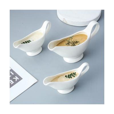 China 2021 Sustainable New Best Seller White Ceramic Sauce Boat Shaped Sauce Dishes With Handles For Steak Hotel Restaurants for sale