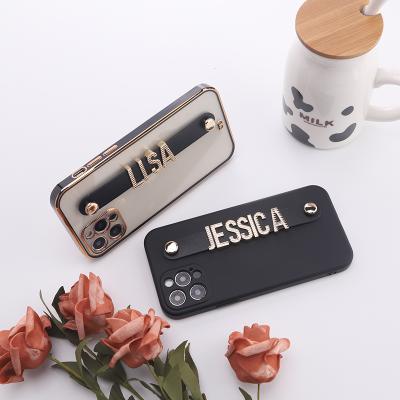 China Anti-fall DIY Metal Letter Charm TPU Silicone Phone Case With Strap For iPhone 13 pro 12 11 x / max xs xr for sale