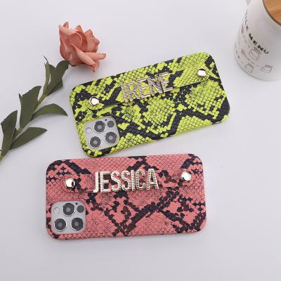 China Custom Anti-fall Design Letter Strap Snakeskin Pattern Custom Leather Phone Case For iPhone Model for sale