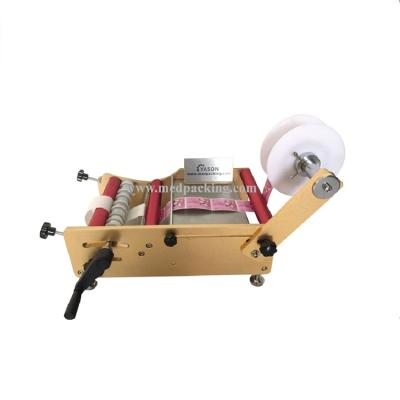 China L100 Beverage Manual Labeling Machine For Round Bottle Cans Jars Portable Hand Labeler for sale