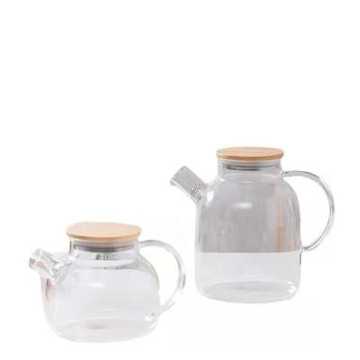 China Sustainable 1000 ml 34oz High Borosilicate Heat Resistant Glass Tea Pot with Handle  and Bamboo Lid Tea Water Pitcher for sale