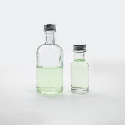 China 1oz 4oz Spirit Glass Bottle Eco-Friendly Clear Long Neck With Silver Aluminum Screw Cap for sale