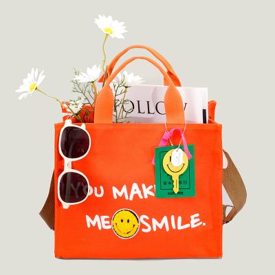 China 2022 Factory Direct Sales High Quality Accept Customized Large Capacity Fashionable Happy Face Painting Canvas Tote Bags Women Handbags Ladies for sale