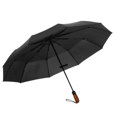 China Minimalist 25 Inches 10 Ribs Portable 3 Folds Open And Close Automatic Travel Handle Wooden Umbrella for sale