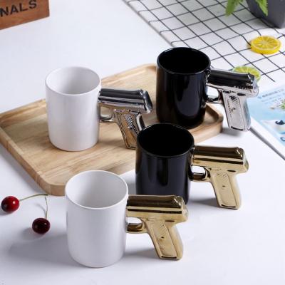 China Viable Silver Mark Gold Mark Coffee Black Coffee White Ceramic Gun Mug Gun Casual Shooting Mug with Gun Handle for sale