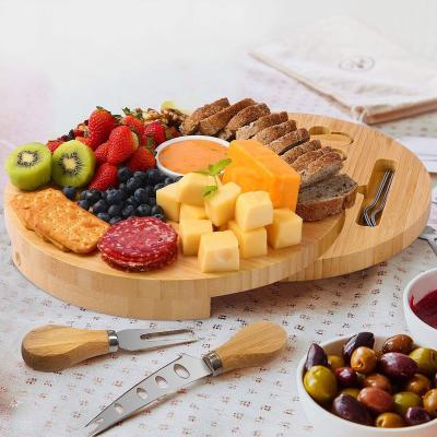 China Sustainable Charcuterie Bamboo Round Tips Swivel Meat Platter Tray with 6 Knives for Housewarming Christmas Thanksgiving Room for sale